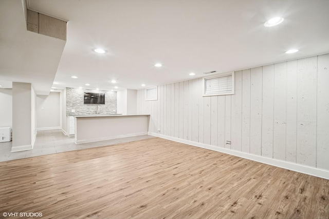 630 Wesley Dr, Park Ridge, IL 60068 - unfurnished living room with light wood-style floors, wood walls, and recessed lighting