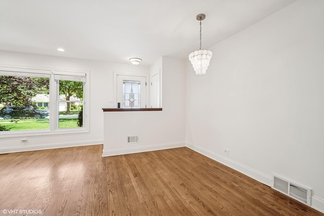 630 Wesley Dr, Park Ridge, IL 60068 - empty room with wood finished floors, a chandelier, and recessed lighting