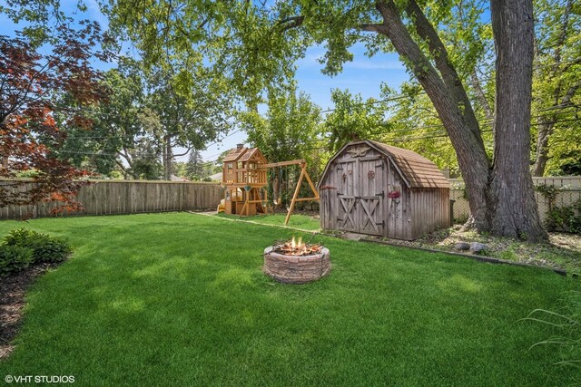 630 Wesley Dr, Park Ridge, IL 60068 - fenced backyard with a shed, a playground, and an outdoor fire pit