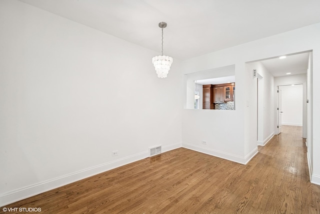 630 Wesley Dr, Park Ridge, IL 60068 - unfurnished dining area with wood finished floors and a chandelier