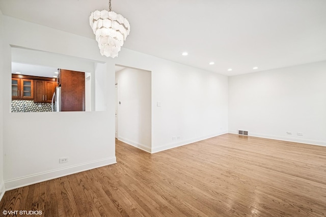 630 Wesley Dr, Park Ridge, IL 60068 - unfurnished living room with light wood-type flooring, a chandelier, and recessed lighting