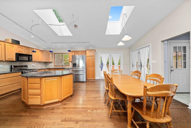 8950 S 84th Ave, Hickory Hills, IL 60457 - kitchen with a skylight, stainless steel appliances, track lighting, vaulted ceiling, and wood finished floors