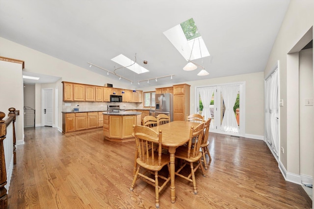 8950 S 84th Ave, Hickory Hills, IL 60457 - dining space featuring a skylight, lofted ceiling, light wood-style floors, and track lighting
