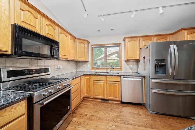 8950 S 84th Ave, Hickory Hills, IL 60457 - kitchen with stainless steel appliances, dark stone counters, light wood-style flooring, decorative backsplash, and track lighting