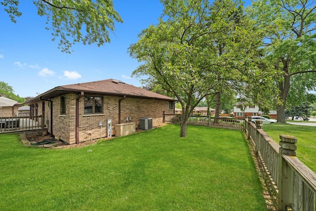 8950 S 84th Ave, Hickory Hills, IL 60457 - rear view of house with a fenced backyard, brick siding, and roof with shingles