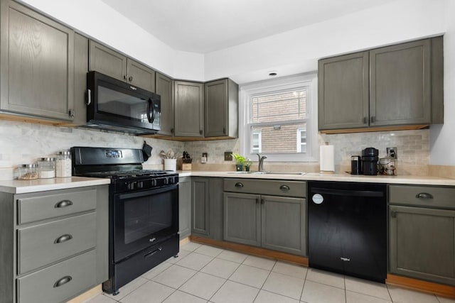 2417 Crosby St, Rockford, IL 61107 - kitchen with black appliances, decorative backsplash, and light countertops