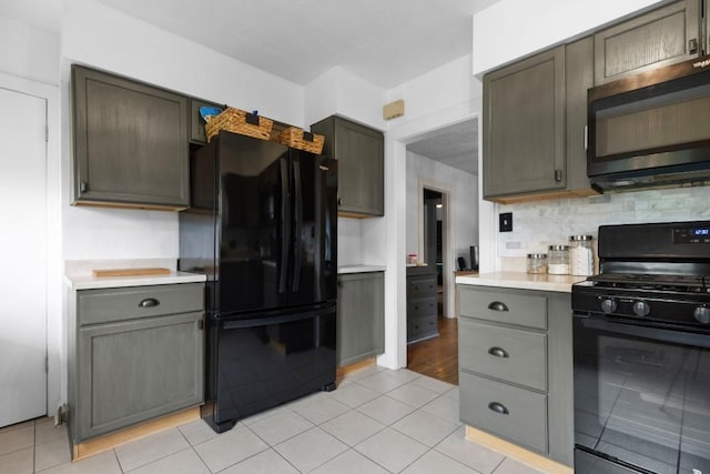 2417 Crosby St, Rockford, IL 61107 - kitchen with black appliances, light countertops, tasteful backsplash, and light tile patterned floors
