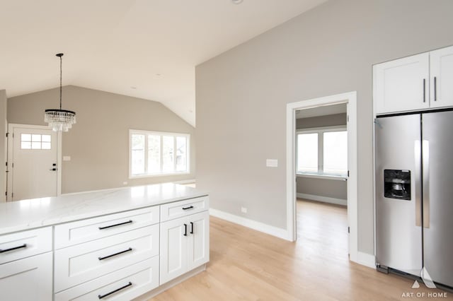 77371/2 Nashville Ave, Burbank, IL 60459 - kitchen with stainless steel refrigerator with ice dispenser, white cabinetry, light wood-type flooring, decorative light fixtures, and a chandelier
