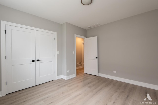 77371/2 Nashville Ave, Burbank, IL 60459 - unfurnished bedroom featuring light wood-type flooring and a closet