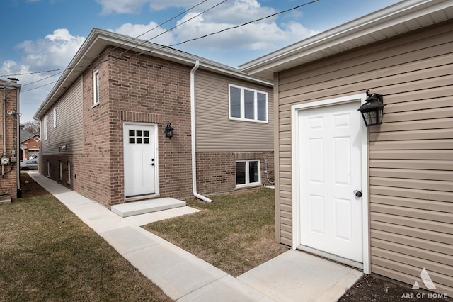 77371/2 Nashville Ave, Burbank, IL 60459 - view of exterior entry with brick siding and a yard