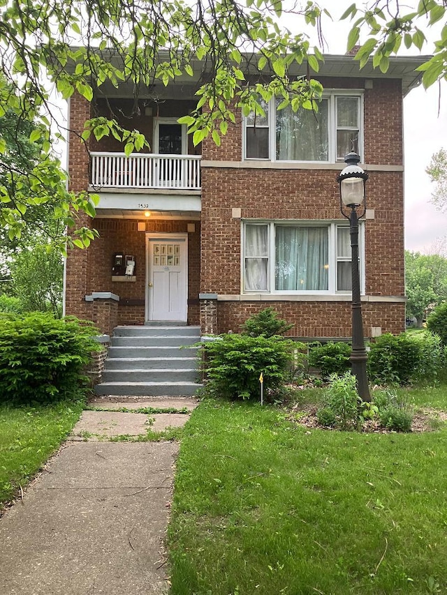 1532 N Ave, Waukegan, IL 60085 - view of front of property featuring a balcony and brick siding