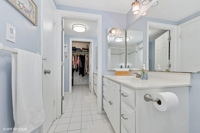 128 Carriage Way Dr Unit 217B, Burr Ridge, IL 60527 - full bathroom with tile patterned floors, vanity, a spacious closet, and a shower