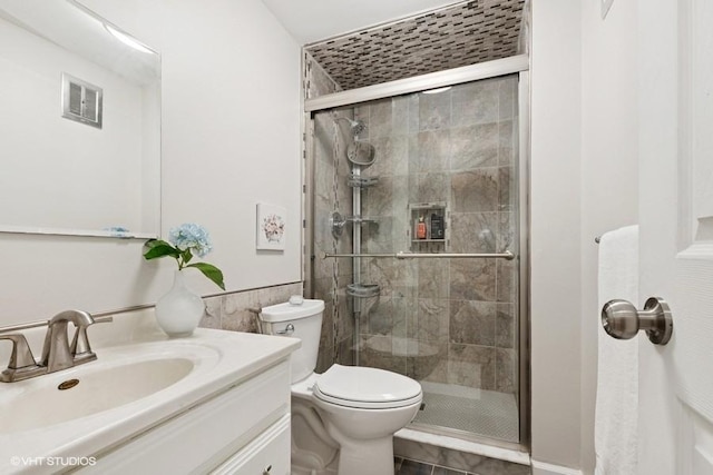 128 Carriage Way Dr Unit 217B, Burr Ridge, IL 60527 - full bathroom featuring a shower stall, vanity, and tile walls