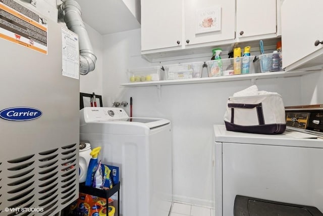 128 Carriage Way Dr Unit 217B, Burr Ridge, IL 60527 - laundry area featuring independent washer and dryer, cabinet space, tile patterned floors, and heating unit