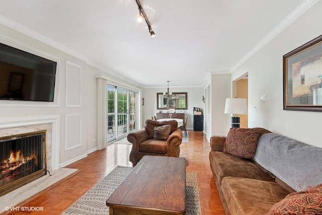 128 Carriage Way Dr Unit 217B, Burr Ridge, IL 60527 - living room with ornamental molding, a high end fireplace, and rail lighting