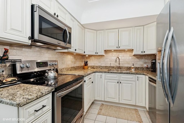128 Carriage Way Dr Unit 217B, Burr Ridge, IL 60527 - kitchen with appliances with stainless steel finishes, light tile patterned floors, and white cabinets