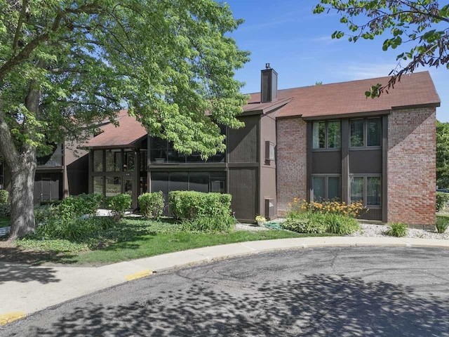 720 Saint Andrews Ln Unit 6, Crystal Lake, IL 60014 - view of front of home featuring brick siding and a chimney