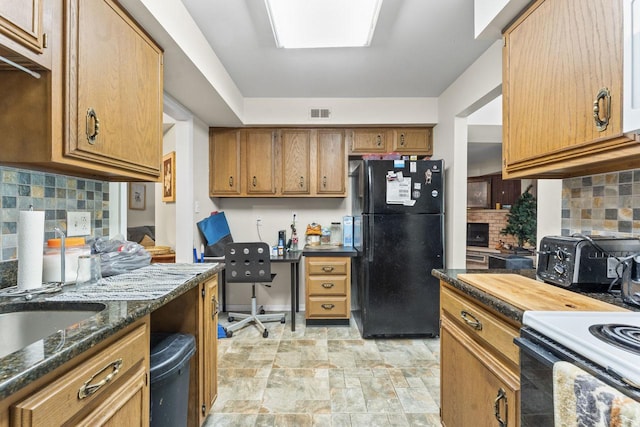 720 Saint Andrews Ln Unit 6, Crystal Lake, IL 60014 - kitchen featuring black appliances, brown cabinetry, stone finish flooring, and tasteful backsplash