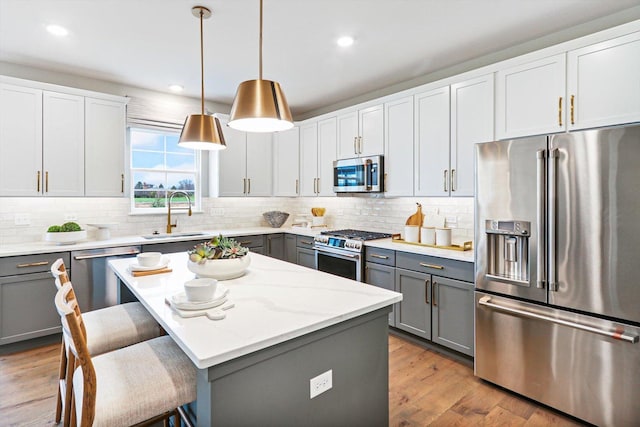 26328 W Sablewood Cir, Plainfield, IL 60585 - kitchen with high quality appliances, gray cabinets, a kitchen breakfast bar, tasteful backsplash, and recessed lighting