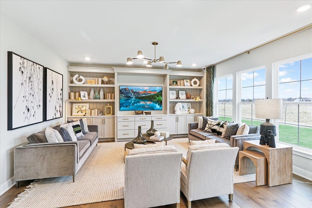 26328 W Sablewood Cir, Plainfield, IL 60585 - living area with wood finished floors, a chandelier, and recessed lighting
