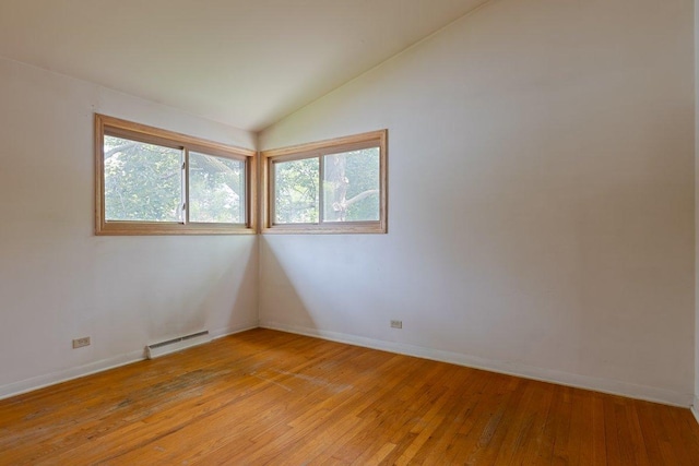 8429 Mason Ave, Morton Grove, IL 60053 - spare room with lofted ceiling, light wood-type flooring, and a baseboard heating unit