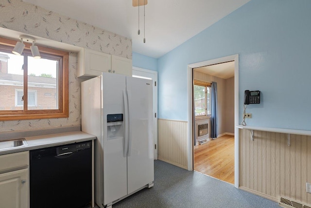 8429 Mason Ave, Morton Grove, IL 60053 - kitchen featuring white fridge with ice dispenser, dishwasher, vaulted ceiling, light floors, and light countertops