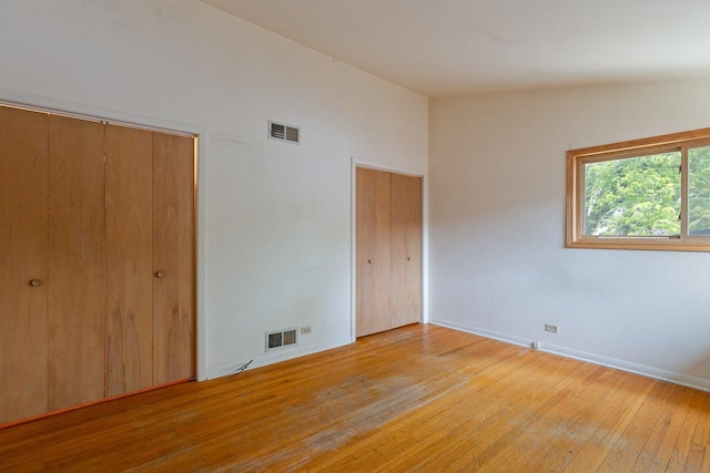 8429 Mason Ave, Morton Grove, IL 60053 - unfurnished bedroom featuring multiple closets and light wood finished floors