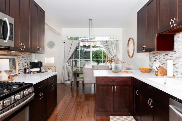 18374 Century Ct, Tinley Park, IL 60477 - kitchen with appliances with stainless steel finishes, light countertops, wood-type flooring, and backsplash