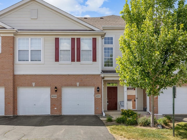 4231 Savoy Ln Unit 4231, Mchenry, IL 60050 - multi unit property with driveway, brick siding, and an attached garage