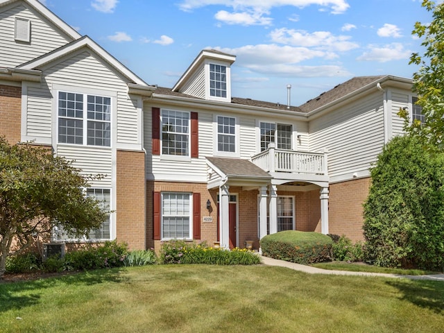 4231 Savoy Ln Unit 4231, Mchenry, IL 60050 - view of front of home with a balcony, a front lawn, and brick siding