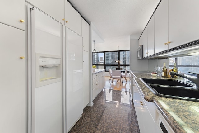 360 E Randolph St Unit 3305, Chicago, IL 60601 - kitchen featuring granite tiled floors, white cabinets, stainless steel microwave, and white fridge with ice dispenser