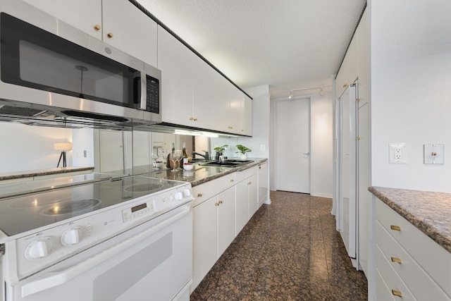 360 E Randolph St Unit 3305, Chicago, IL 60601 - kitchen with electric stove, stainless steel microwave, white cabinetry, granite floors, and a textured ceiling