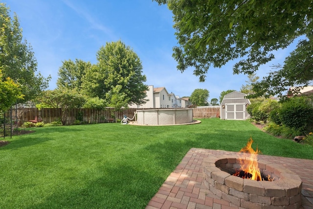 1519 Parkside Dr, Plainfield, IL 60586 - fenced backyard with an outdoor fire pit, a shed, and a patio