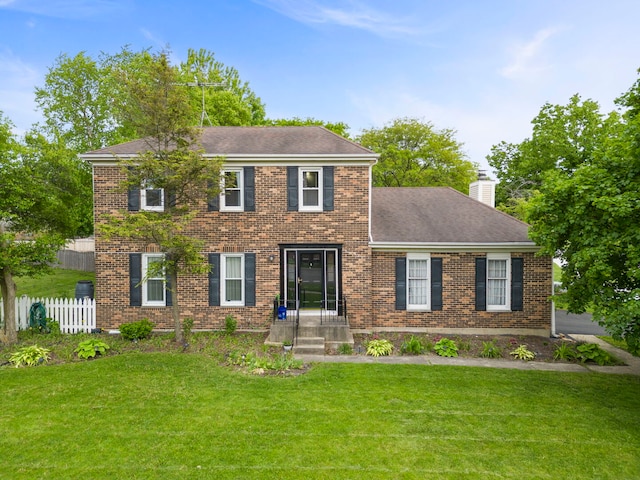 1004 Evergreen Dr, Carol Stream, IL 60188 - colonial-style house featuring brick siding, a chimney, and a shingled roof