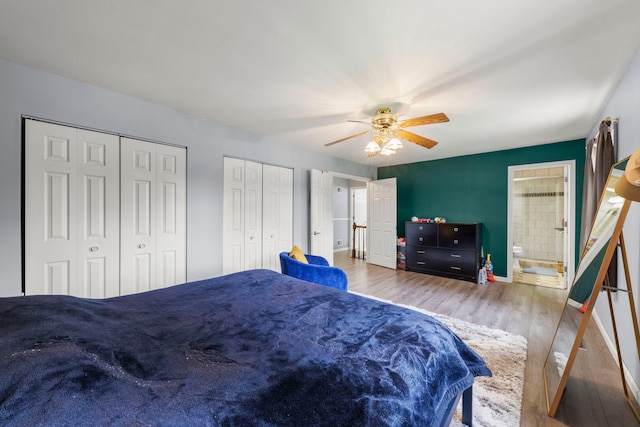 1004 Evergreen Dr, Carol Stream, IL 60188 - bedroom featuring two closets, wood finished floors, a ceiling fan, and connected bathroom