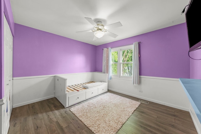 1004 Evergreen Dr, Carol Stream, IL 60188 - unfurnished bedroom with wood finished floors, wainscoting, and ceiling fan