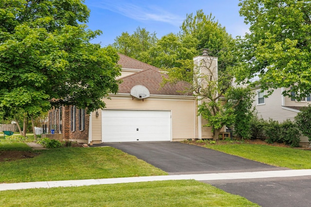 1004 Evergreen Dr, Carol Stream, IL 60188 - view of front of home featuring driveway, a chimney, a front yard, and a garage