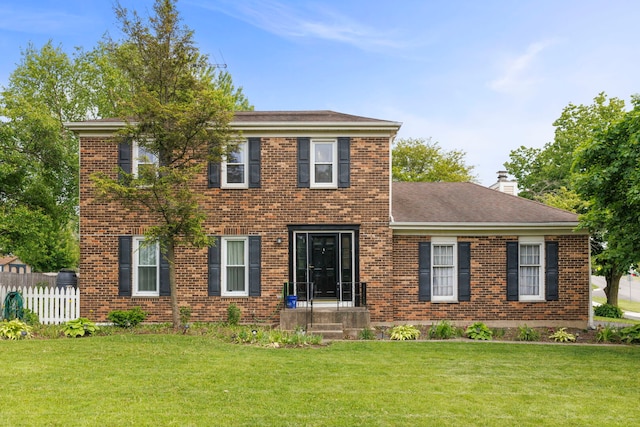 1004 Evergreen Dr, Carol Stream, IL 60188 - colonial inspired home with brick siding, a chimney, and roof with shingles