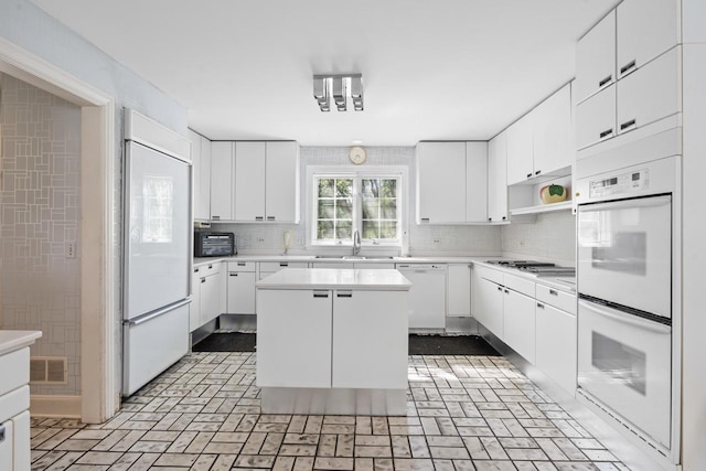 937 Braeburn Rd, Inverness, IL 60067 - kitchen with white appliances, light countertops, backsplash, and white cabinets