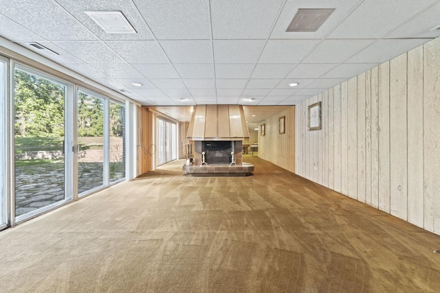937 Braeburn Rd, Inverness, IL 60067 - unfurnished living room with a fireplace with raised hearth, carpet flooring, wooden walls, and a drop ceiling