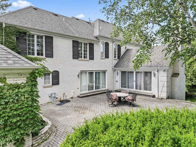 937 Braeburn Rd, Inverness, IL 60067 - back of property with a patio area, a shingled roof, and brick siding