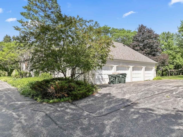937 Braeburn Rd, Inverness, IL 60067 - view of side of home featuring an attached garage, driveway, and roof with shingles