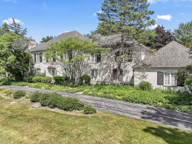 937 Braeburn Rd, Inverness, IL 60067 - view of front of house with a chimney, a front yard, and a shingled roof