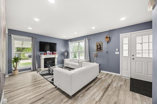 2853 Forestview Dr, Carpentersville, IL 60110 - living area with a glass covered fireplace, light wood finished floors, and recessed lighting