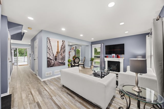 2853 Forestview Dr, Carpentersville, IL 60110 - living area with light wood-style flooring, recessed lighting, and a glass covered fireplace