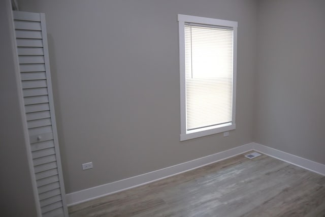 8346 S Baltimore Ave, Chicago, IL 60617 - unfurnished room with plenty of natural light and wood finished floors