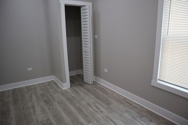 8346 S Baltimore Ave, Chicago, IL 60617 - unfurnished bedroom with wood finished floors and a closet