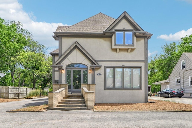 18229 Riegel Rd, Homewood, IL 60430 - tudor-style house featuring stucco siding, a shingled roof, and asphalt driveway