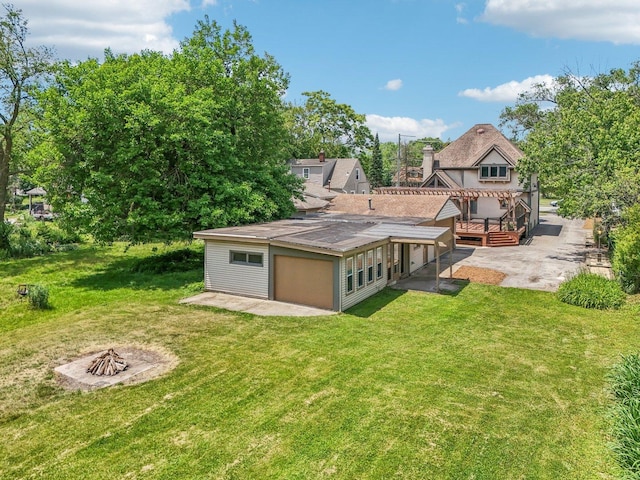 18229 Riegel Rd, Homewood, IL 60430 - rear view of house featuring a patio area, a fire pit, a deck, and a lawn