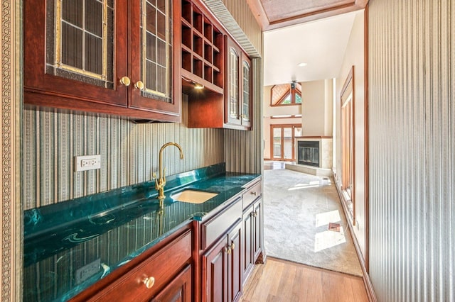 18229 Riegel Rd, Homewood, IL 60430 - kitchen with dark countertops, light wood-type flooring, glass insert cabinets, and wallpapered walls